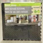 Black interlocking anti-fatigue floor tiles with diamond plate texture for gym or garage in Lagos, Nigeria.