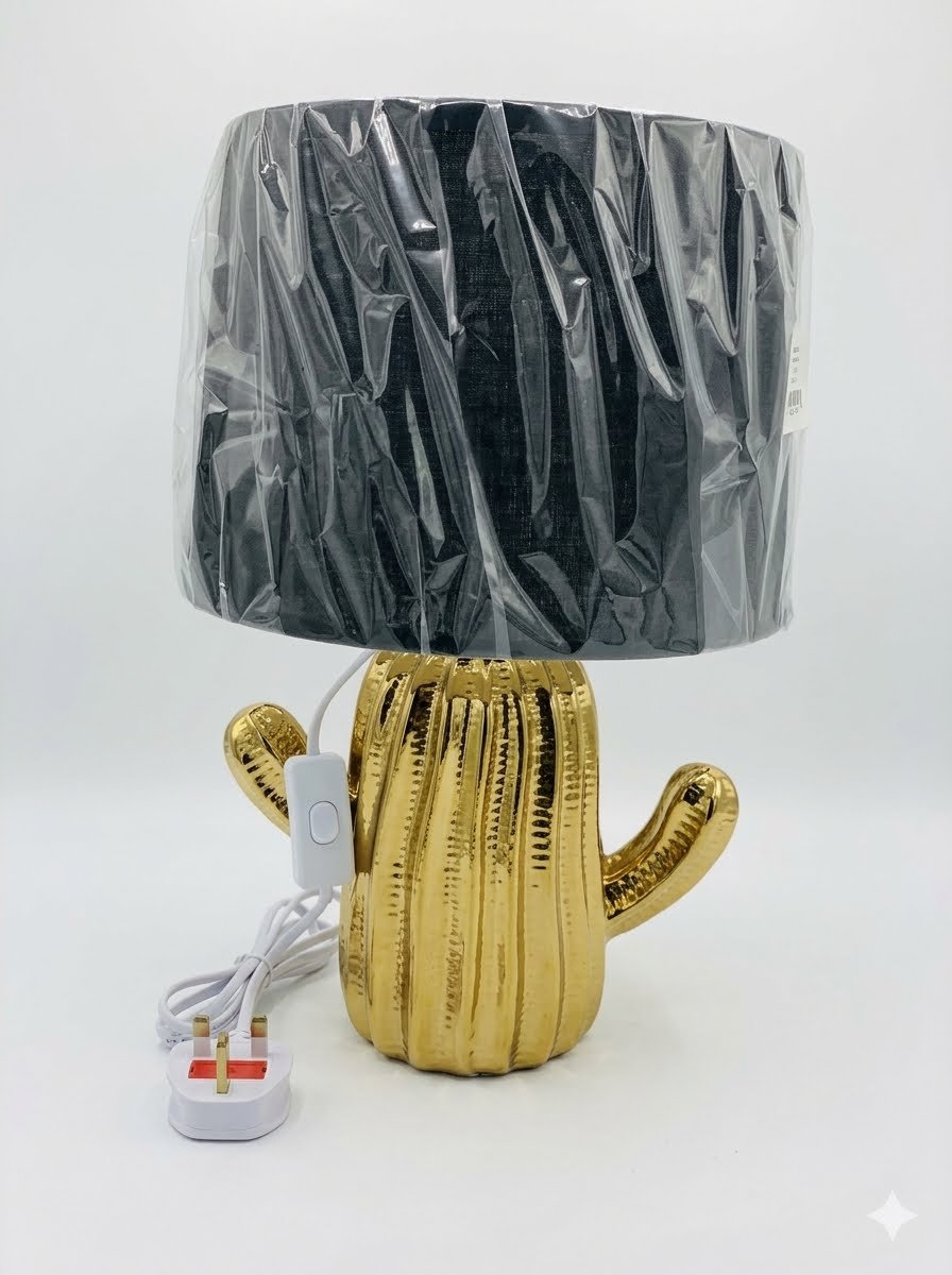 Contemporary 38.5cm gold-plated ceramic cactus-shaped table lamp Contemporary 38.5cm gold-plated ceramic cactus-shaped table lamp with a black fabric shade and UK plug, Lagos, Nigeria