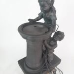 Playful children garden water feature statue with stone-effect finish and LED lights in Lagos, Nigeria