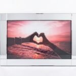 Heart hands forming a sunset silhouette on framed landscape wall art for Lagos, Nigeria home décor.