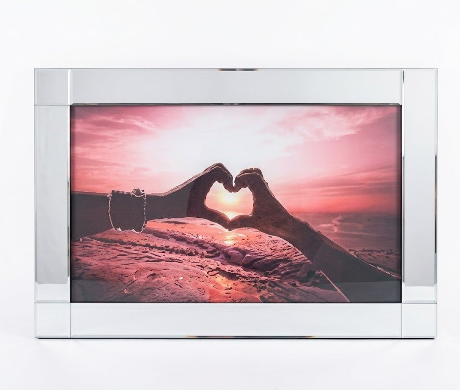 Heart hands forming a sunset silhouette on framed landscape wall art for Lagos, Nigeria home décor.