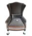 Grey velvet wingback armchair with orange tangerine piping and lumbar pillow in Lagos, Nigeria