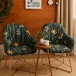 Set of 2 dark green velvet armchairs with orange bird of paradise floral print and gold legs in Lagos, Nigeria