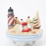 Handcrafted nautical candle jar topper with lighthouse, sailboat, and sand castle in Lagos, Nigeria