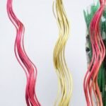 Tall bundles of pink and yellow spiral curly willow twigs for floor vase home decoration in Lagos, Nigeria