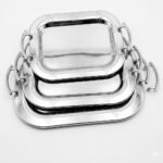Three piece set of Loreno silver serving trays with polished metallic surfaces for hosting in Lagos, Nigeria