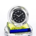 Crystal ball table clock with a black face and white numerals on a tiered multi-colour glass base in Lagos, Nigeria.
