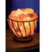 Himalayan pink salt chunks in a black metal wire basket lamp for luxury home wellness and décor in Lagos, Nigeria