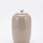 Shiny taupe 45.5cm ceramic jar with a decorative silver bird lid for luxury home styling in Lagos, Nigeria