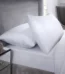Pair of crisp white T400 housewife pillowcases on a luxury bed setup for home décor in Lagos, Nigeria