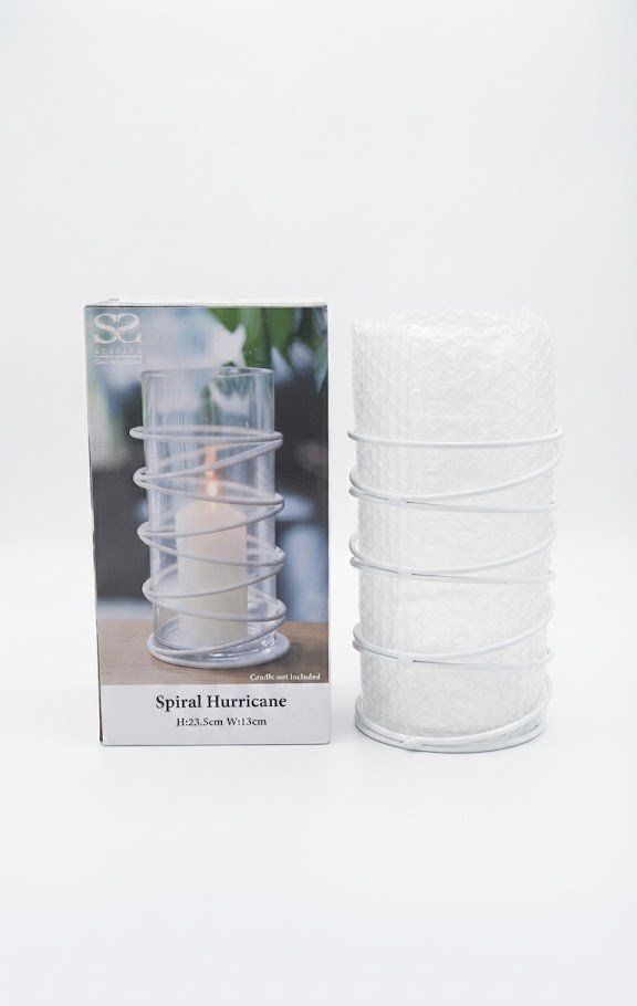 Modern clear glass cylinder hurricane vase with a decorative white metal spiral wire wrap for pillar candles in Lagos