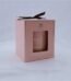 Soft pink gift box with a black ribbon bow containing a Baltus Orris and Sandalwood scented soy candle in Lagos, Nigeria