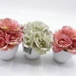 Pink and white artificial rose flowers in small white pots for home décor in Lagos, Nigeria