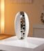 White and silver ceramic egg vase with a decorative pierced hole design for home decor in Lagos, Nigeria.