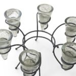Clear glass cylindrical pillar candle holder featuring a sleek black metal ring base, Lagos, Nigeria