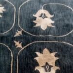 Soft grey room rug with minimalist pink line pattern for bedroom and living room flooring in Lagos, Nigeria