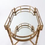Oval gold-finished metal side table with a highly reflective mirror top for home décor in Lagos, Nigeria