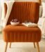 Burnt orange accent chair with cushioned seat for living room décor in Lagos, Nigeria