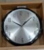 Modern Wall Clock Black with silver face and black frame in a cardboard box, available in Lagos, Nigeria.