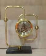 Gold geometric skeleton table clock with moving gears on a black base for luxury home decor in Lagos, Nigeria.