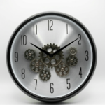Silver and black Enarose wall clock with exposed rotating gears and Arabic numerals for home decor in Lagos, Nigeria.