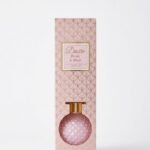 Desire 100ml Peony & Blush reed diffuser in a pink diamond-patterned round glass bottle with gold cap in Lagos, Nigeria