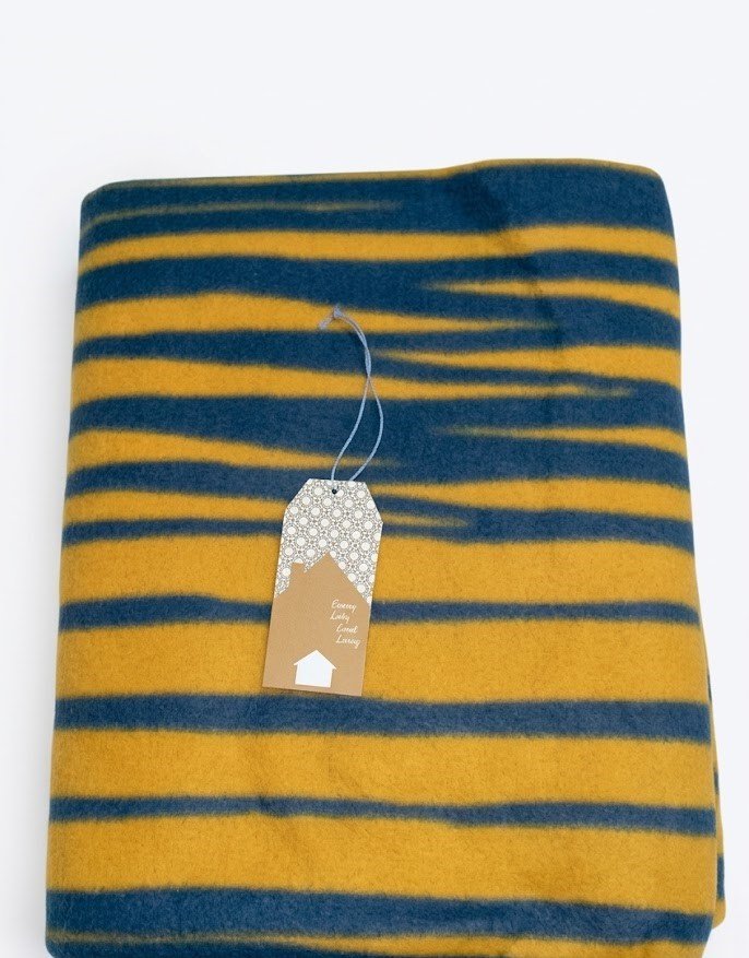Soft dark blue fleece blanket with oblique line patterns for cozy home decor in Lagos, Nigeria