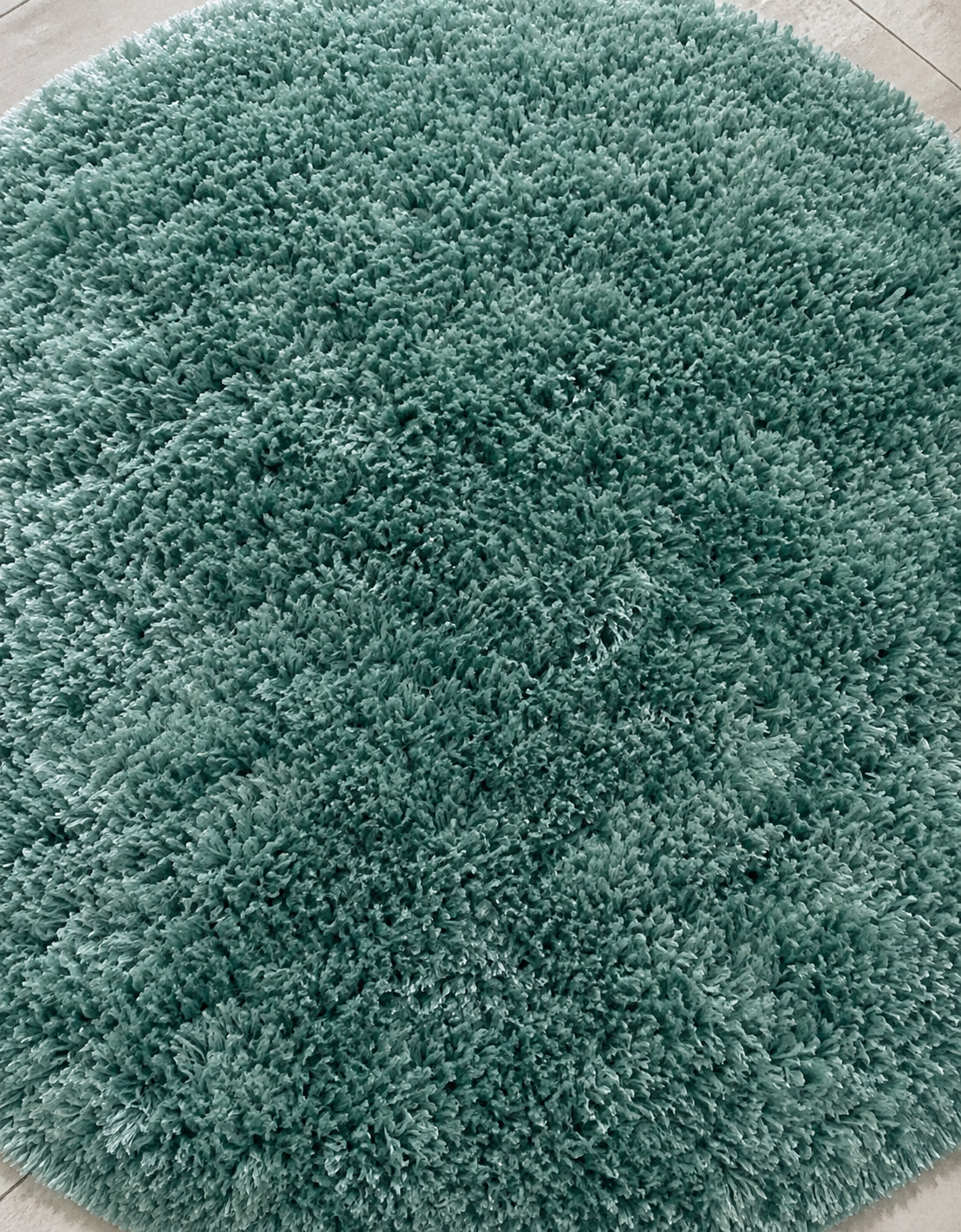 Light orange room rug with blue, black, and green geometric patterns for home flooring in Lagos, Nigeria
