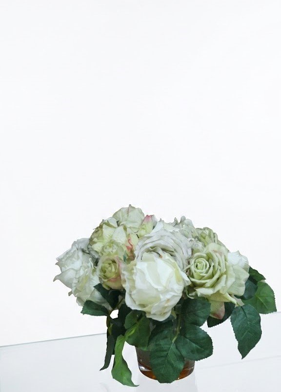 Assorted roses arranged in a glass vase with red, pink, yellow and white blooms for home décor and gifting in Lagos Nigeria