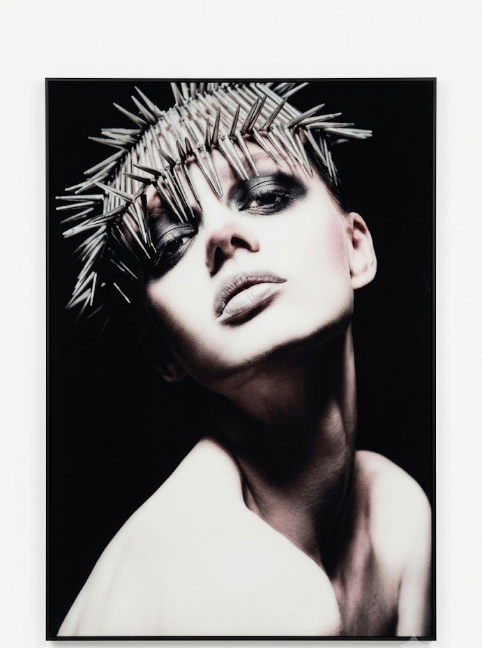 Monochrome fashion wall art featuring a model wearing a dramatic metallic spike headband in Lagos, Nigeria.