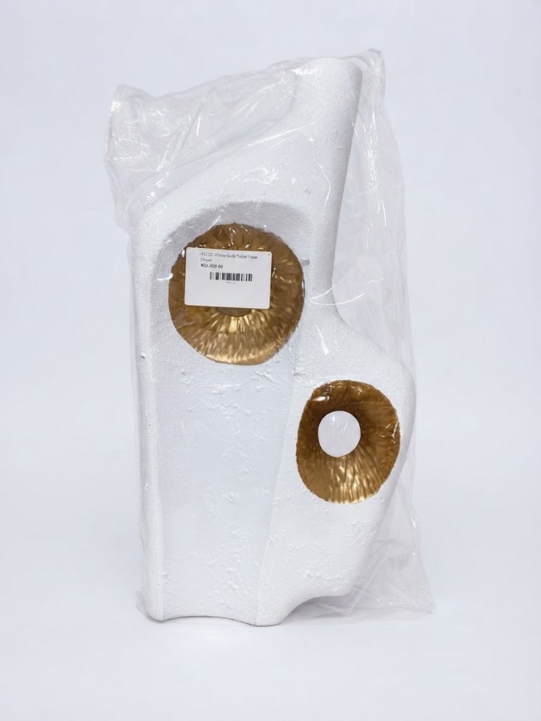 White textured abstract vase with metallic gold circular accents for modern table decor in Lagos, Nigeria