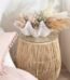 Natural woven rattan side table in an hourglass shape for indoor and outdoor patio décor in Lagos, Nigeria