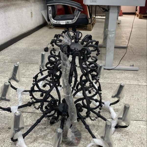 Large black 10-arm wrought iron chandelier with ornate scrollwork for luxury lighting in Lagos, Nigeria