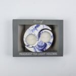 Interlocking lilac and white Black Iris Fragranced Ying and Yang Tea Light Holders on a table in Lagos, Nigeria