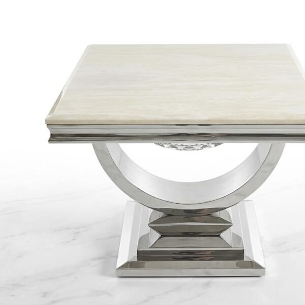 Cream composite marble side table with chrome U-shaped base for luxury living room decor in Lagos, Nigeria.