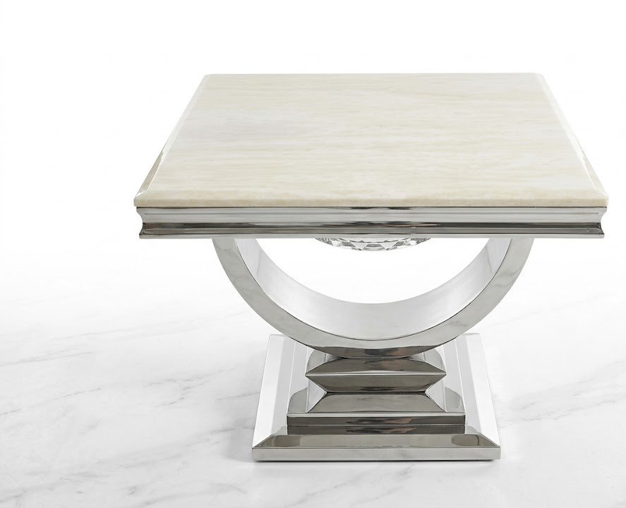 Cream composite marble side table with chrome U-shaped base for luxury living room decor in Lagos, Nigeria.