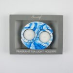 Interlocking blue and white Sea Lily Fragranced Yin and Yang Tea Light Holders on a table in Lagos, Nigeria.
