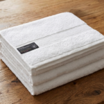 Crisp white 100% cotton bath towel for luxury home and hotel bathroom use in Lagos, Nigeria.