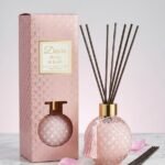 Pink round diamond-textured glass Desire Peony & Blush reed diffuser with a tassel in a pink gift box, Lagos, Nigeria