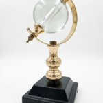 Modern VejiA desk decor with a white marble pedestal, gold circular frame, and visible skeleton movement in Lagos, Nigeria