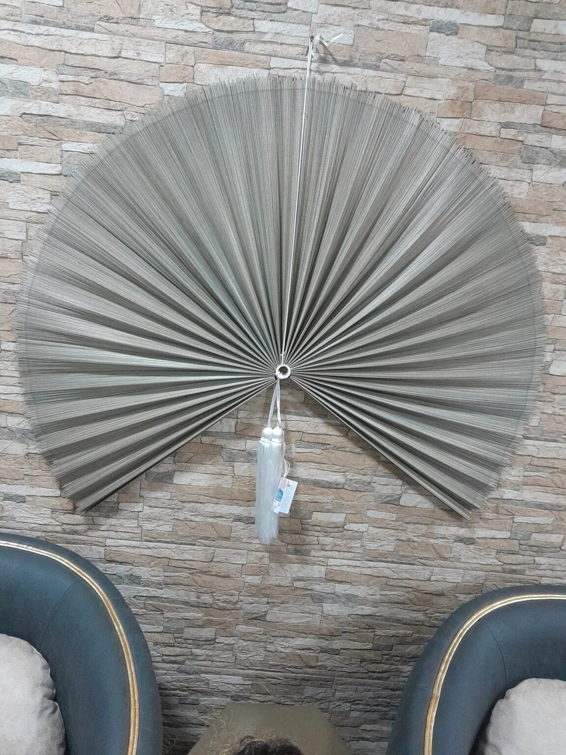 Decorative wall mirror reflecting a living room interior in a Lagos home