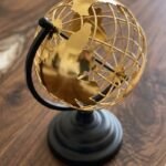 Gold and black steel world globe table décor for home and office styling in Lagos, Nigeria